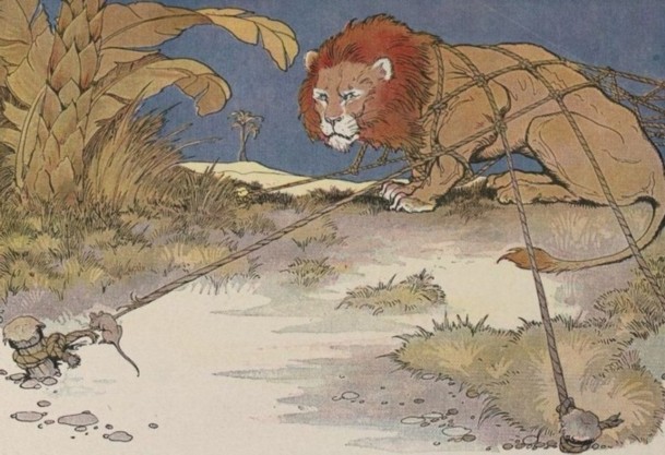 A mouse stands near a lion whose paw is caught in a net.