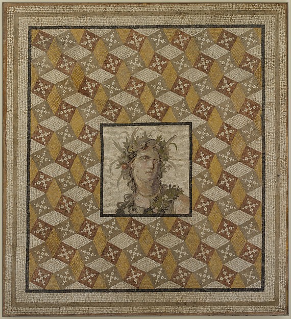 A Roman mosaic floor panel showing the head of Spring surrounded by patterned pieces.